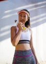 Asian woman with sportswear on a white wall outdoors. beauty perfect body Slim Fit fitness sexy girl happy and relaxing. Royalty Free Stock Photo