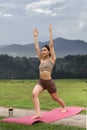 Asian woman sporty practicing yoga at public park outdoor stretching her body. Healthy active lifestyle