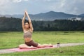 Asian woman sporty practicing yoga at public park outdoor stretching her body. Healthy active lifestyle