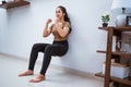 asian woman squating against the wall at home Royalty Free Stock Photo