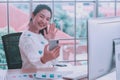 Asian woman staff working,smartphone and pc computer,happy smiling at home office,remote presenting marketing plan report online Royalty Free Stock Photo