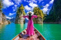 Asian woman standing on boat in Ratchaprapha dam Khao sok national park at Suratthani,Thailand Royalty Free Stock Photo