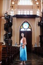 Asian woman is standing a Christian church for make a wish and pray for hope and encouragement in life. Rituals and beliefs in Royalty Free Stock Photo