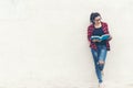 Asian woman standing and holding a book on wall white background. Royalty Free Stock Photo