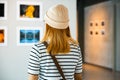 Asian woman standing she looking art gallery in front of colorful framed Royalty Free Stock Photo