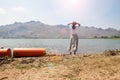 Asian woman standing near the river with mountain view on background. Happy travel and lifestyle Royalty Free Stock Photo