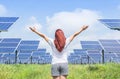 Asian woman standing raised up arms celebrate achievements freedom success in solar cell power station.