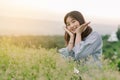 Asian woman Standing smiling in the fields of green grass in the morning sun With a happy face Royalty Free Stock Photo