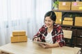 Asian woman startup small business at home office. Online seller entrepreneur young asian woman use tablet checking online order. Royalty Free Stock Photo