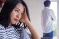 An Asian woman is stressed and anxious about the love problems between her husband after an intense quarrel. Concepts of lovers ha Royalty Free Stock Photo