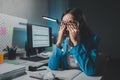 Asian woman is stressed while working on laptop, tired asian businesswoman with headache at office, feeling sick at work, Stressed Royalty Free Stock Photo