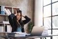 Asian woman are stressed while working on laptop, Tired businesswoman with headache at office, feeling sick at work Royalty Free Stock Photo