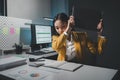 Asian woman is stressed while working on laptop, tired asian businesswoman with headache at office, feeling sick at work, Stressed Royalty Free Stock Photo