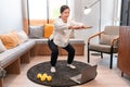 Asian woman stretching legs and arms before exercise and using laptop to conducting online yoga class Royalty Free Stock Photo