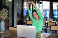 Asian woman stretching after reading book and work hard and smiling in coffee shop Royalty Free Stock Photo