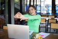 Asian woman stretching after reading book and work hard and smiling in coffee shop Royalty Free Stock Photo