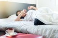 Asian woman stretching and yawning on bed after wake up in the morning Royalty Free Stock Photo