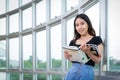 Asian woman student read text book in her university library Royalty Free Stock Photo