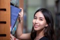 Asian woman student read text book in her university library Royalty Free Stock Photo