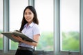 Asian woman student read text book in her university library Royalty Free Stock Photo