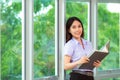 Asian woman student read text book in her university library Royalty Free Stock Photo