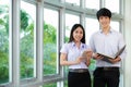 Asian woman student read text book in her university library Royalty Free Stock Photo