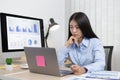 Asian woman is studying online via the internet with a cheerful smile, stay home, New normal, Covid-19 coronavirus Royalty Free Stock Photo