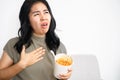 Asian woman suddenly choking while eating noodle that stuck in her throat, she tries to open her mouth to breathe Royalty Free Stock Photo