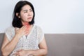 Asian woman suffering from chronic heartburn from acid reflux , sore throat concept Royalty Free Stock Photo