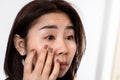 Asian woman suffering from eye inflammation feeling pain ,redness Royalty Free Stock Photo