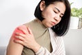 Asian woman suffering from frozen shoulder with pain and stiffness