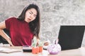 Asian woman suffering from lower back pain sitting too long on chair working on computer Royalty Free Stock Photo