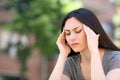 Asian woman suffering migraine attack in the street Royalty Free Stock Photo