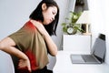 Asian Woman suffering Neck, Shoulder, and Lower Back Pain due to Office Syndrome from Prolonged Computer Work Royalty Free Stock Photo