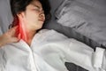 Asian woman suffering from neck sprain or a crick in her neck during sleeping in the bed Royalty Free Stock Photo