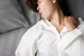 Asian woman suffering from neck sprain or a crick in her neck during sleeping in the bed