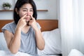 Asian woman suffering from sinus infection having runny nose Royalty Free Stock Photo