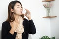 Asian woman suffering from sore throat dinking glass of water Royalty Free Stock Photo