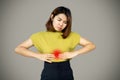 Asian woman suffering from stomach ache, heartburn