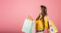 Asian woman in sunglasses, holding shopping bags with delight Royalty Free Stock Photo