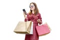 Asian woman with sunglasses using the mobile phone while carrying shopping bags Royalty Free Stock Photo