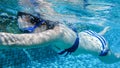 Asian woman swimmer girl swimming fast in blue pool