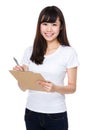 Asian woman take note on clipboard Royalty Free Stock Photo