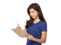 Asian woman take note on clipboard Royalty Free Stock Photo