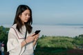 Asian woman  take a selfie phone,  in the tourist area behind the fog and mountains with a smiling face take a selfie phone Royalty Free Stock Photo