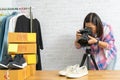 Asian woman taking photo to shoes with digital camera Royalty Free Stock Photo