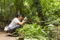 Asian woman taking photos in autumn forest Royalty Free Stock Photo