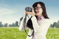 Asian woman taking picture using digital camera Royalty Free Stock Photo
