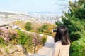 Asian woman taking pictures of Aerial view of Seoul city with smartphone