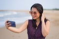 Asian woman taking selfie with mobile phone - lifestyle photo of young happy and beautiful Korean girl taking self portrait on Royalty Free Stock Photo